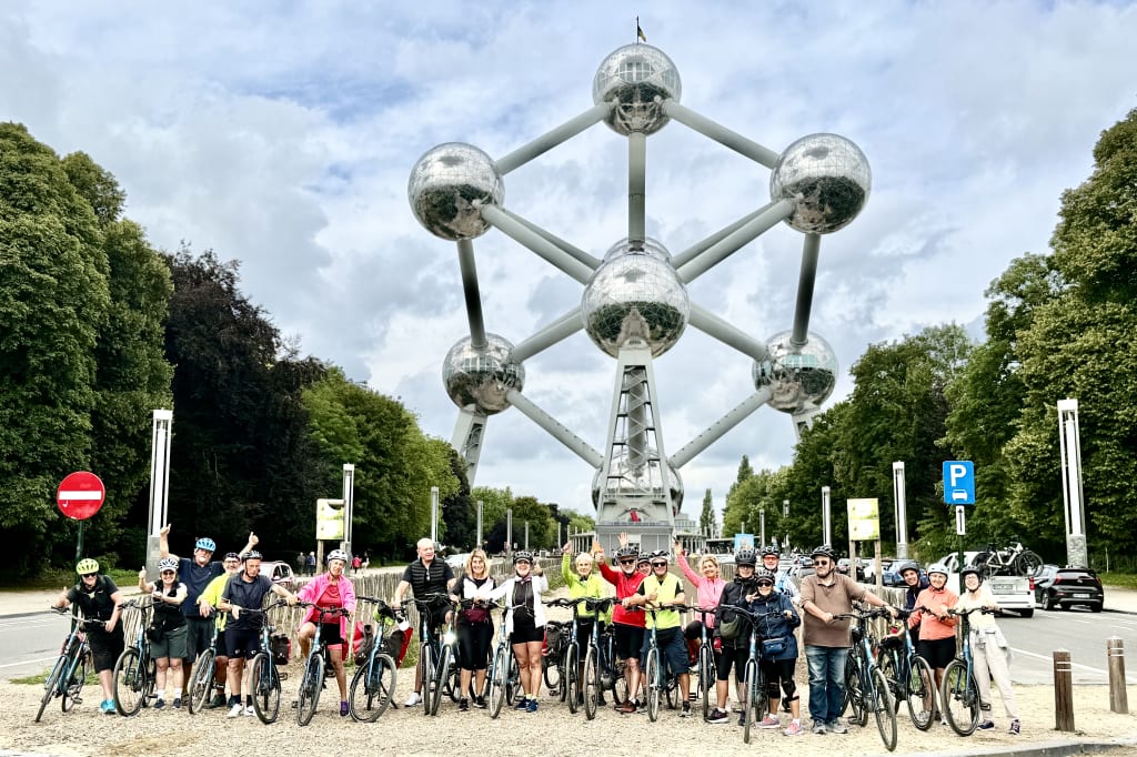 Gruppo in bici davanti all'Atomium di Bruxelles, simbolo iconico dell’Expo 1958.