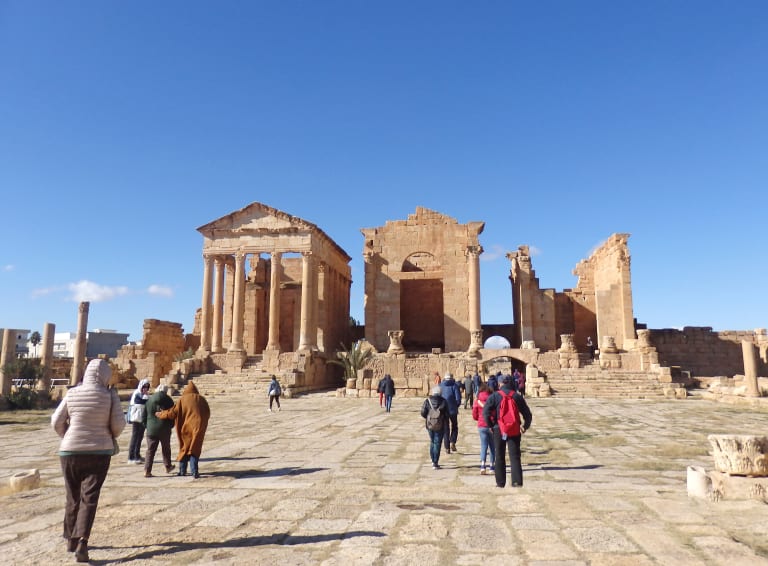 Turisti fra i templi romani del Capitolium di Sbeitla, tappa culturale in Tunisia