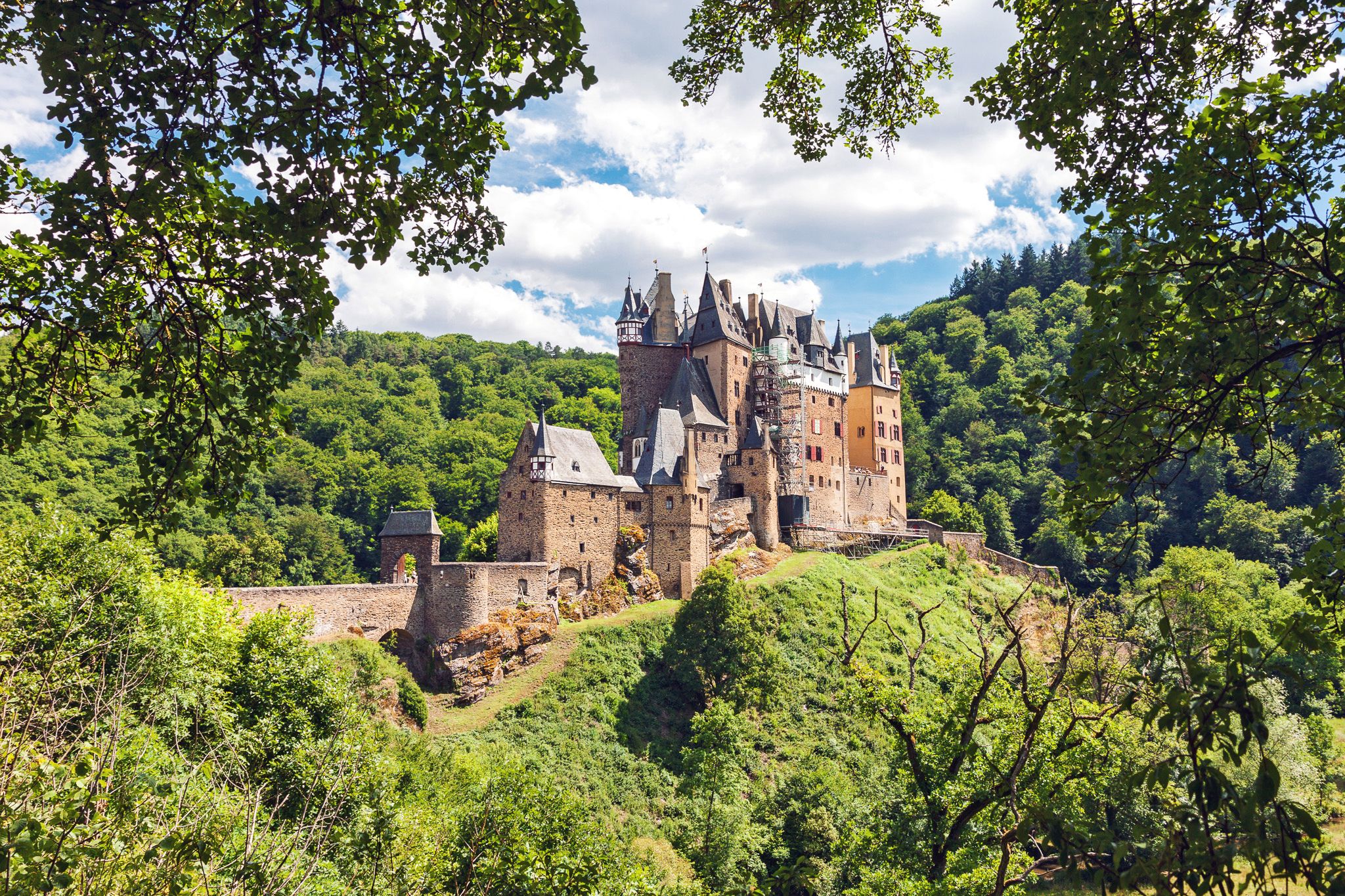 Eltz Castle surrounded by greenery in Rhineland-Palatinate, Germany.