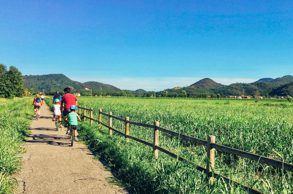 Persone in bicicletta lungo un percorso immerso nella natura, Parco regionale dei Colli Euganei