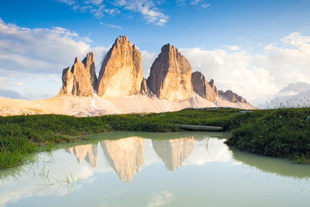 Tre cime di Lavaredo riflesse nell'acqua limpida del fiume Adige, macchia erbosa, turismo ecosostenibile, Alto Adige