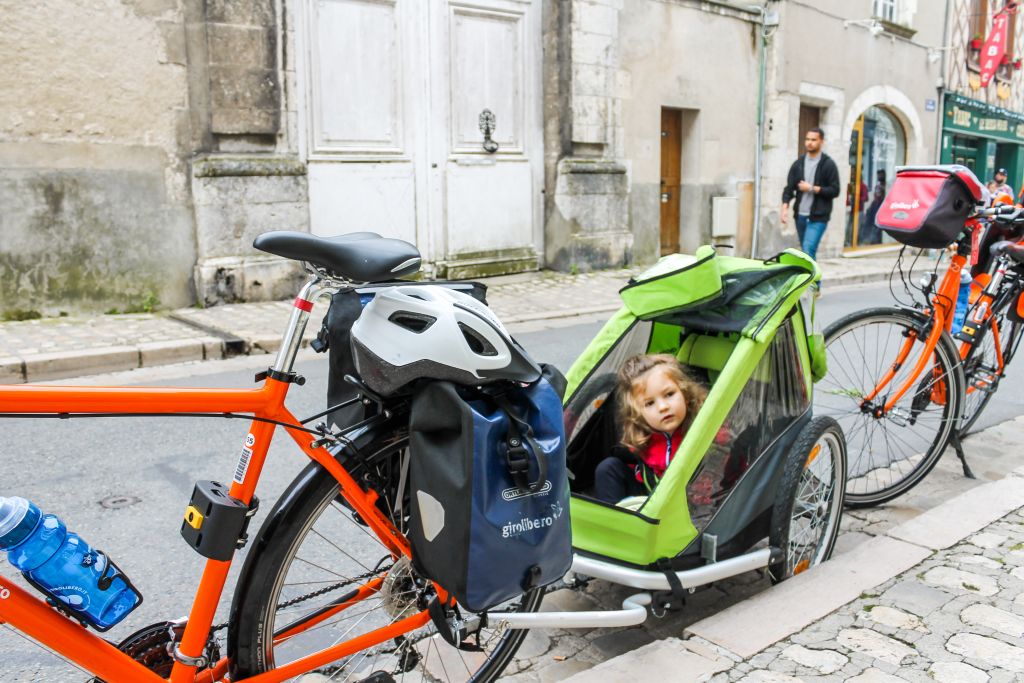 Cargo bike with children sitting on board, parked in a village street in the Loire Valley.