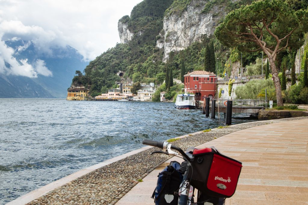Fahrrad auf einem Gehweg am Ufer des Gardasees abgestellt, Von den Alpen in den Veneto