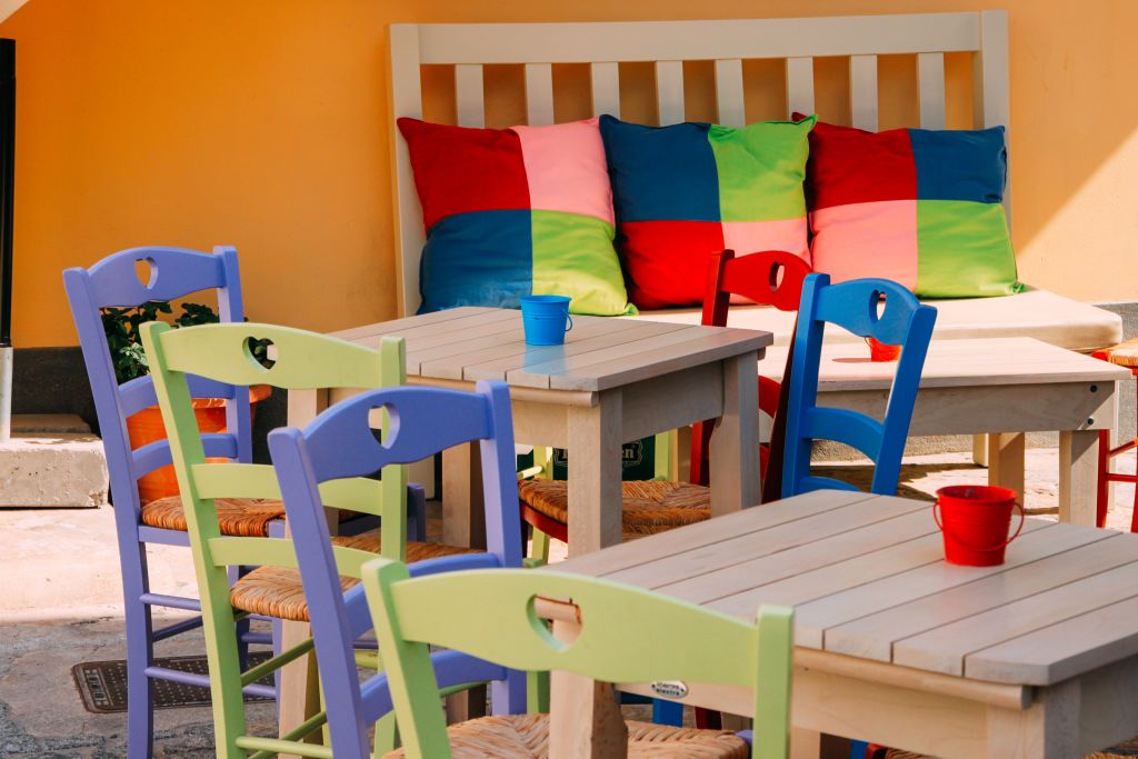 Colorful tables and chairs in a traditional Greek taverna, Greece.