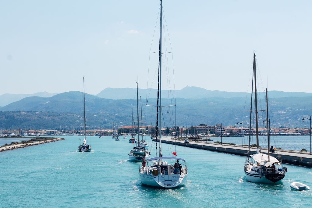 Sailboats in a characteristic bay between hills and turquoise sea
