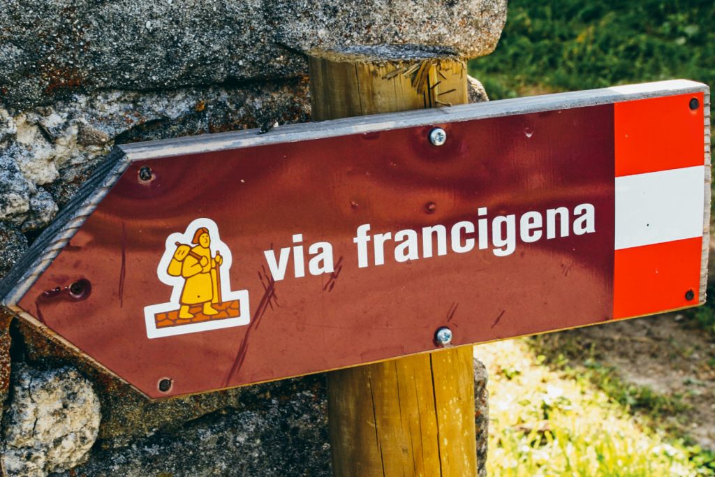 Cartello segnaletico per la Via Francigena nella campagna toscana.