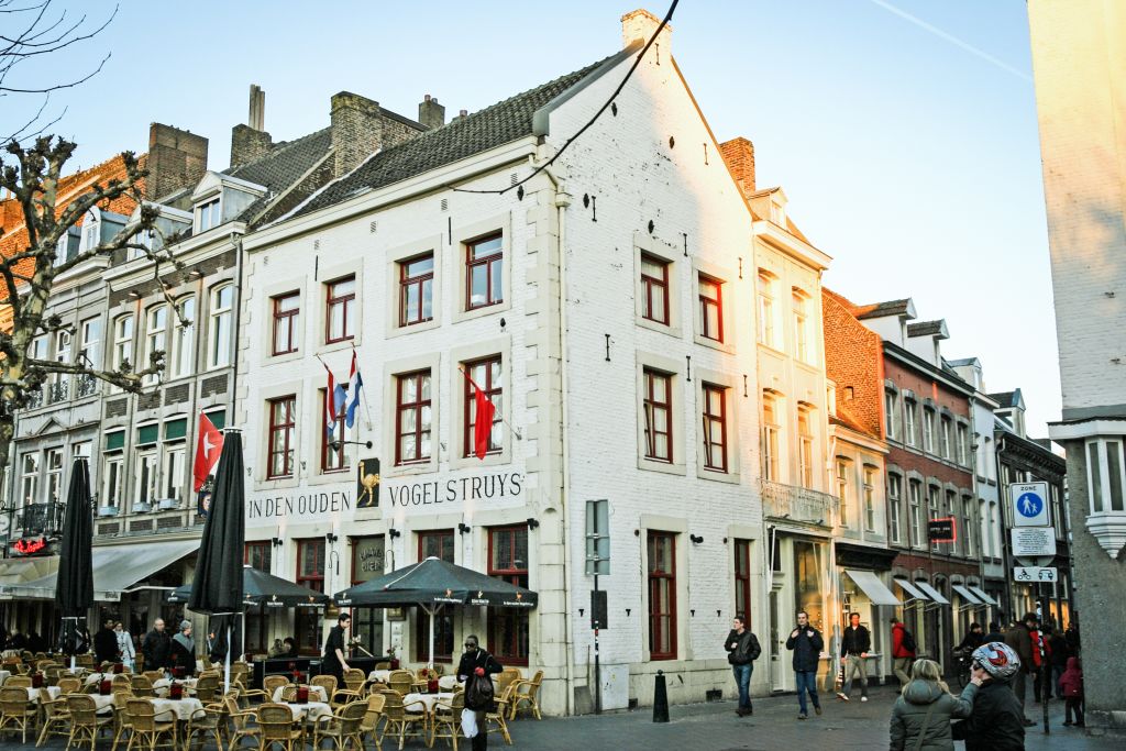 Historic buildings with outdoor cafes in Breda, Netherlands.