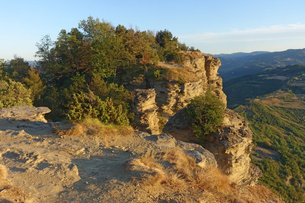 Formazione rocciosa lungo la Via degli Dei, circondata da vegetazione.
