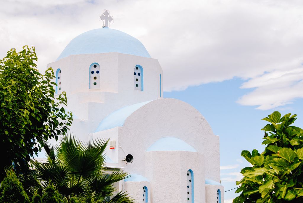White dome and greenery on the island of Santorini, Greece.