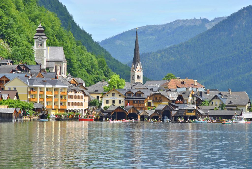 Veduta del villaggio di Hallstatt e del suo riflesso sul lago, circondato dalle montagne del Salzkammergut.