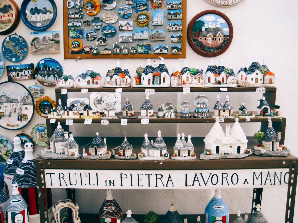 Wall decorated with souvenirs and traditional Apulian ceramics, Italy.
