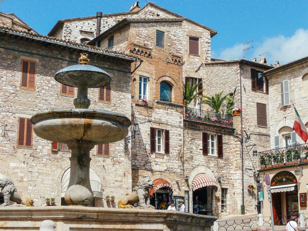 Central square with fountain and stone buildings.