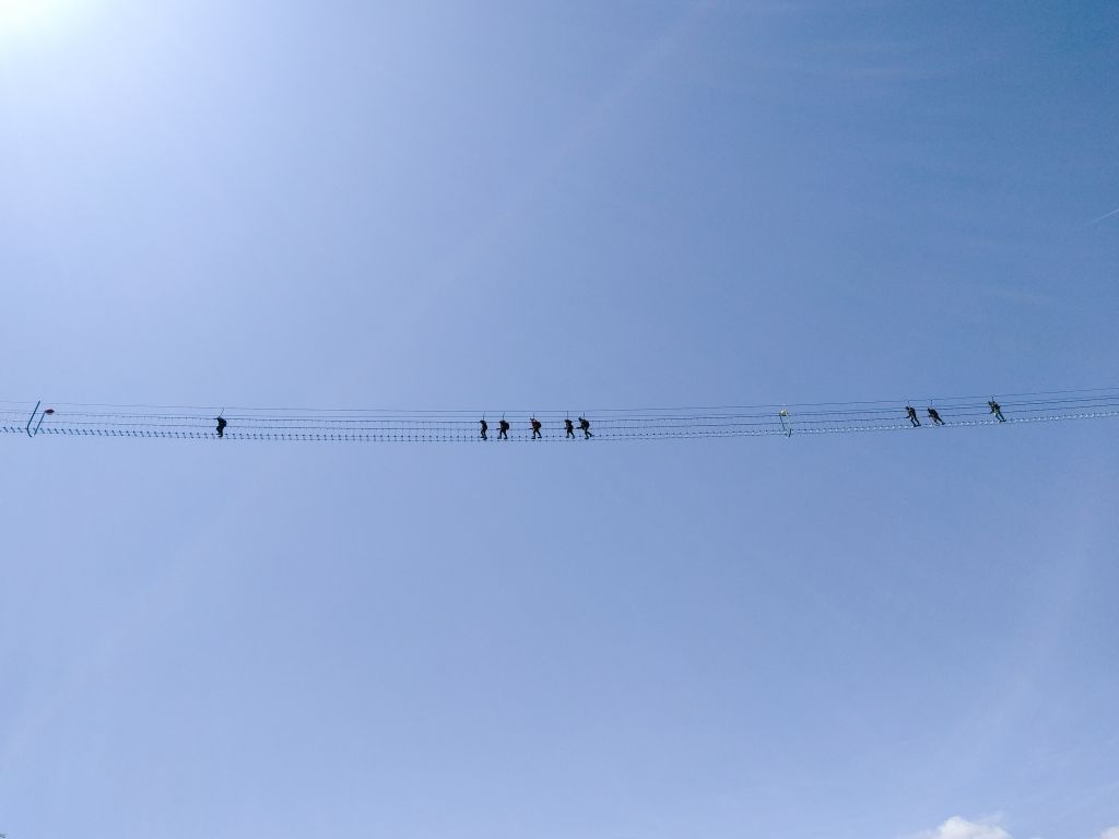 Escursionisti attraversano un ponte sospeso panoramico