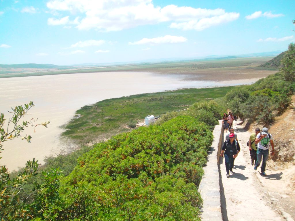 Turisti in viaggio con "Girolibero" su un sentiero panoramico con vista su un lago salato in Tunisia