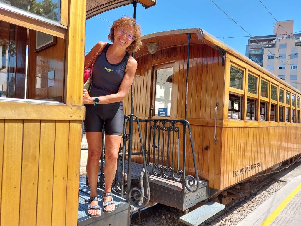 Donna in viaggio con Girolibero sul trenino giallo di Maiorca, Spagna.