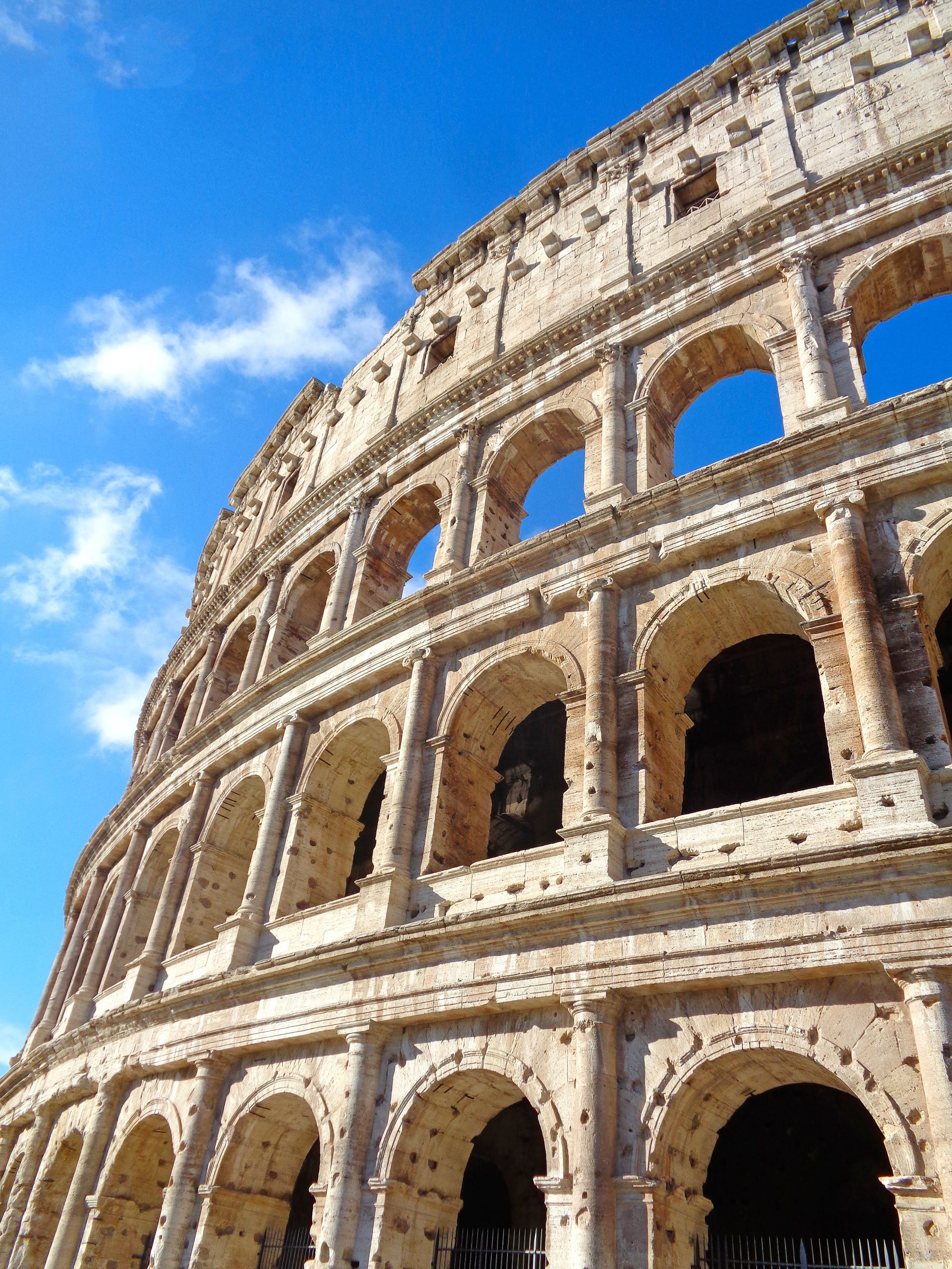 The Colosseum viewed from below with blue sky in the background, Rome.