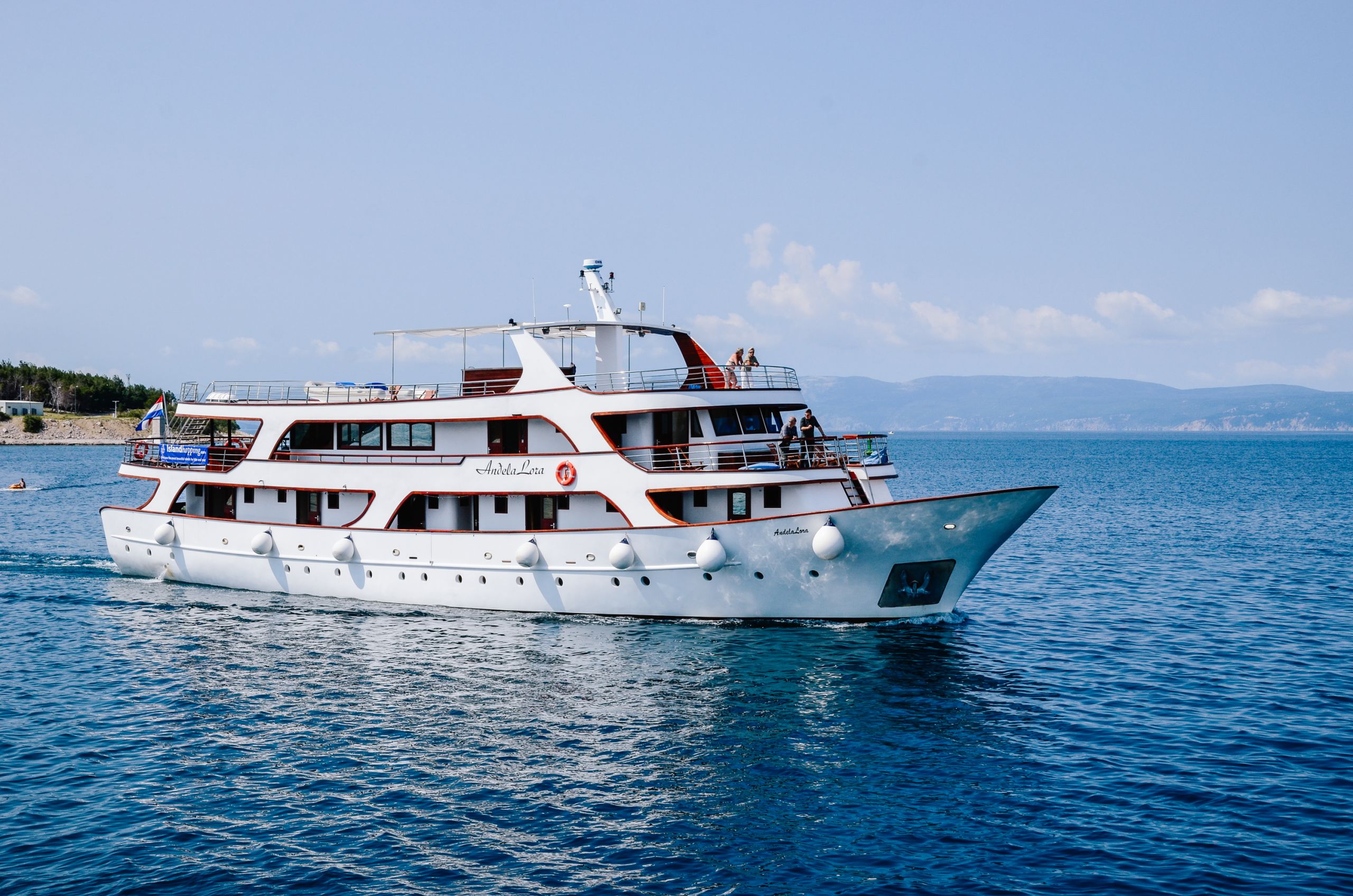 Boat sailing in the open sea, bike and boat holidays