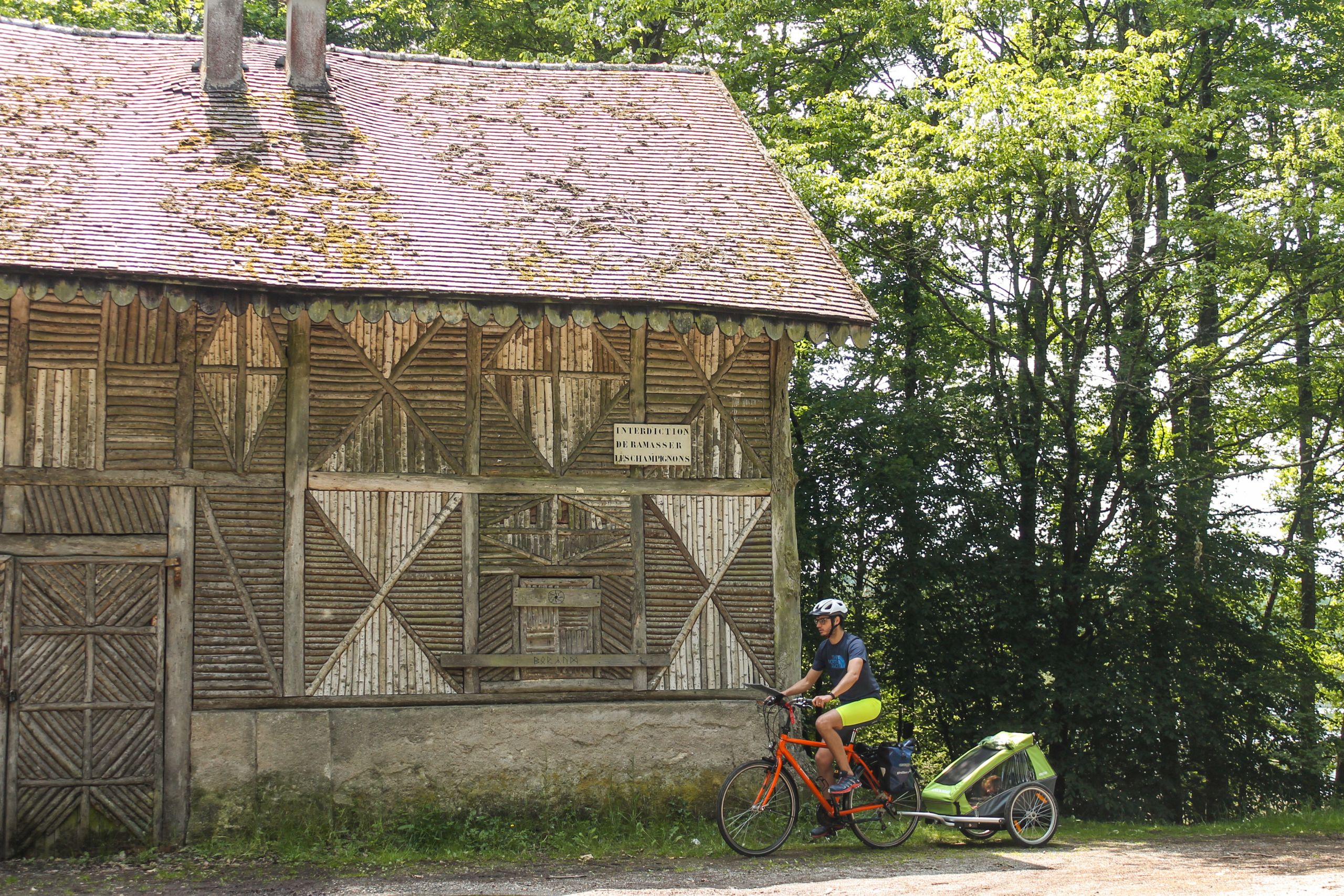 Ein Radfahrer hielt vor einem alten Gebäude aus Stein und Holz in der Landschaft des Loiretals an.