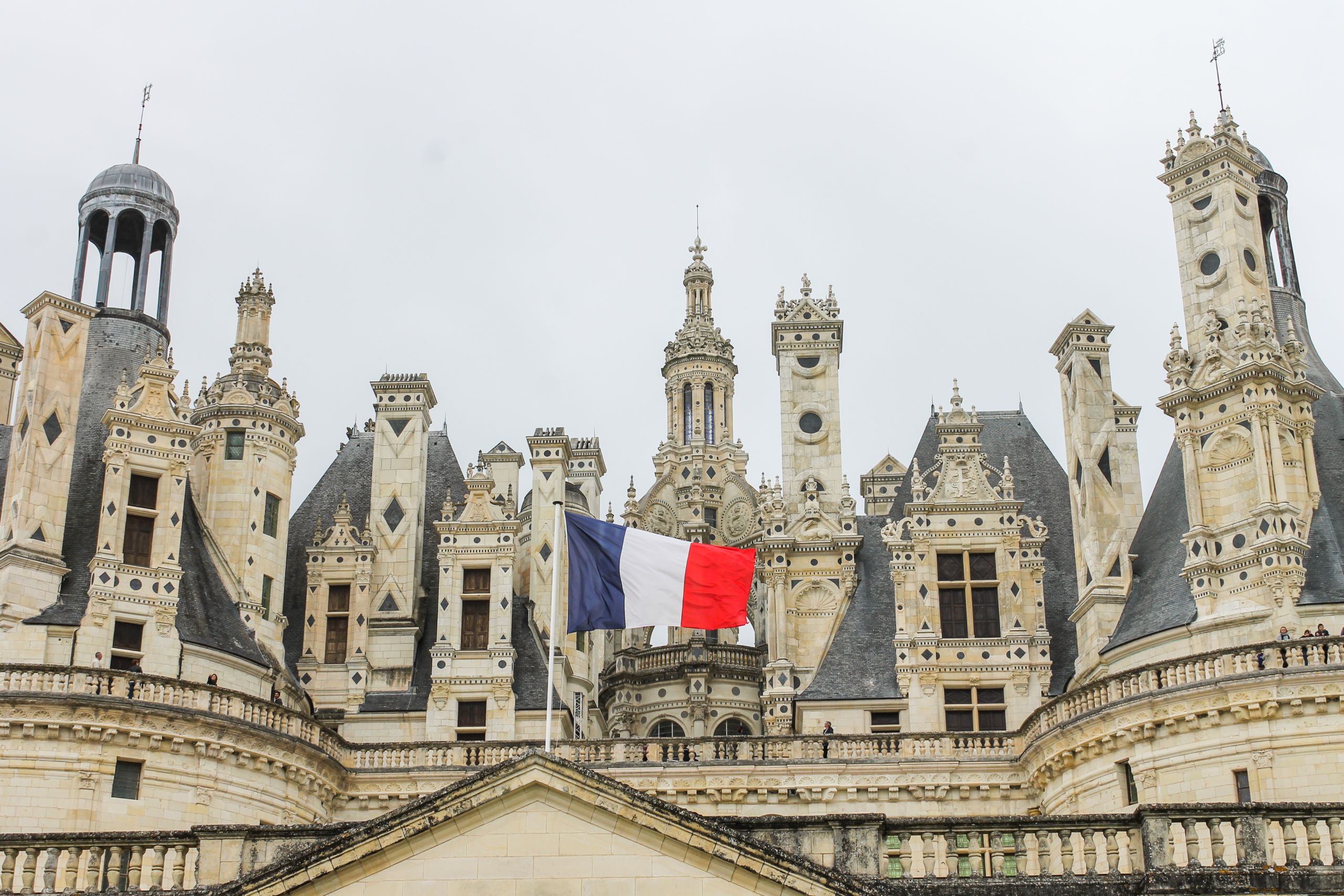 Architectural detail of Chambord Castle with french flag