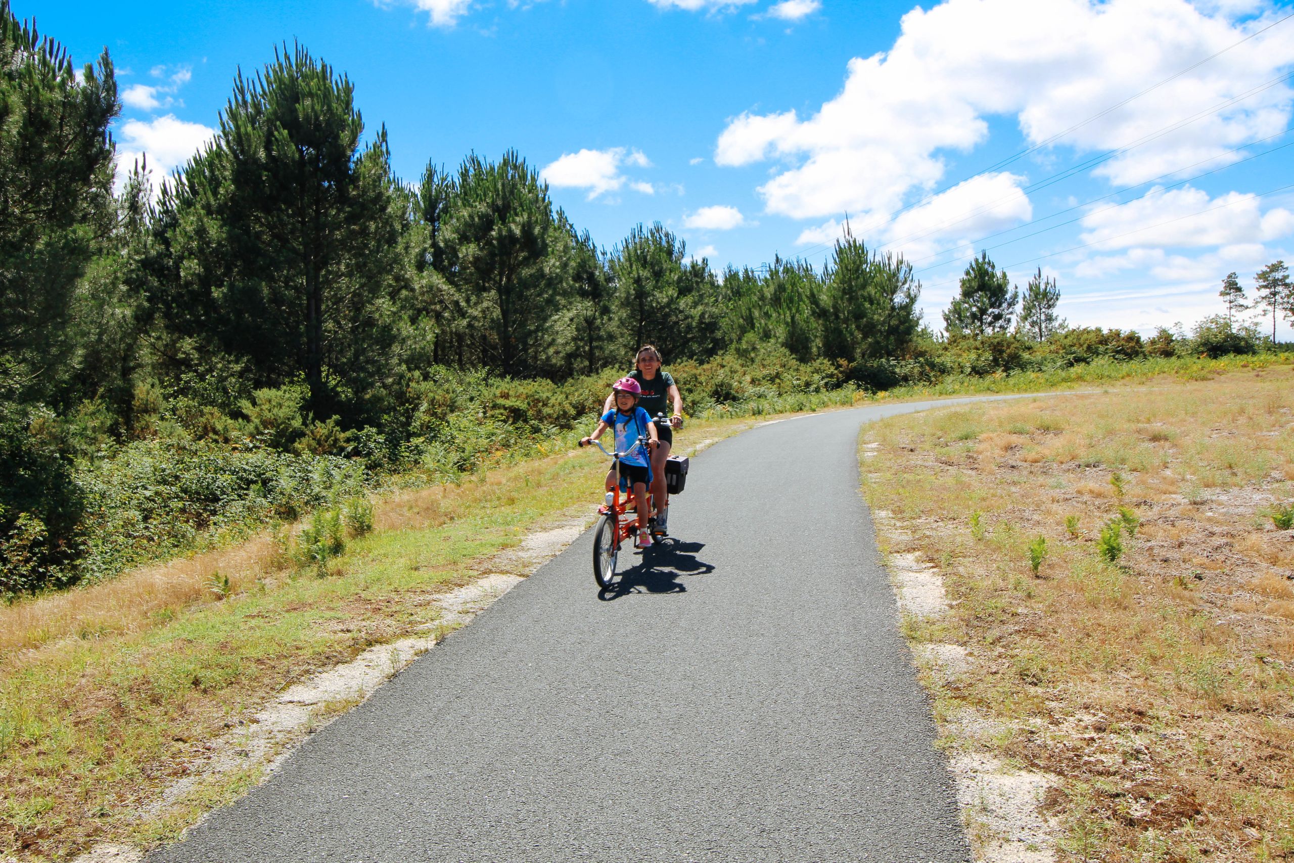 Turista in bicicletta su un sentiero boschivo vicino alla spiaggia, Francia