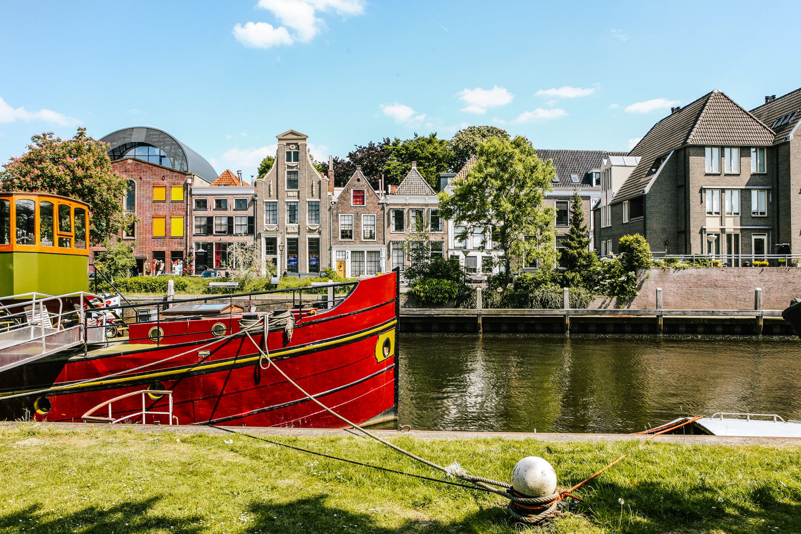 Red boat near colorful houses in Amersfoort, Netherlands.