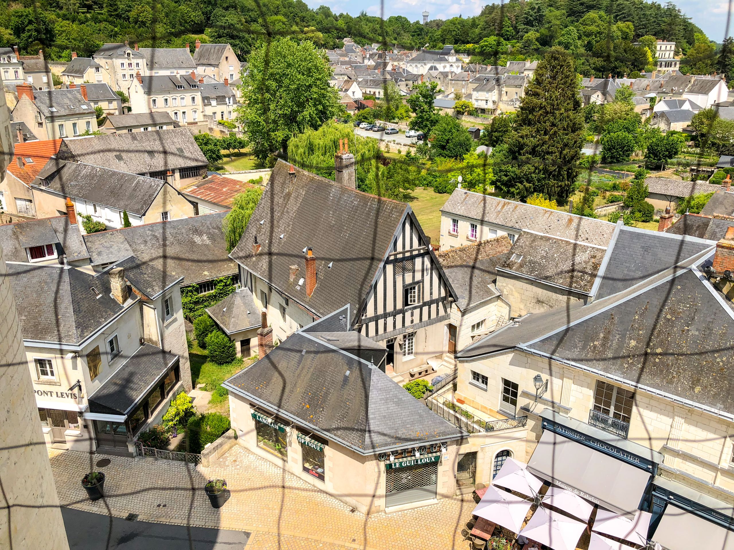 A charming village scene with rooftops and a cathedral in the Loire Valley.