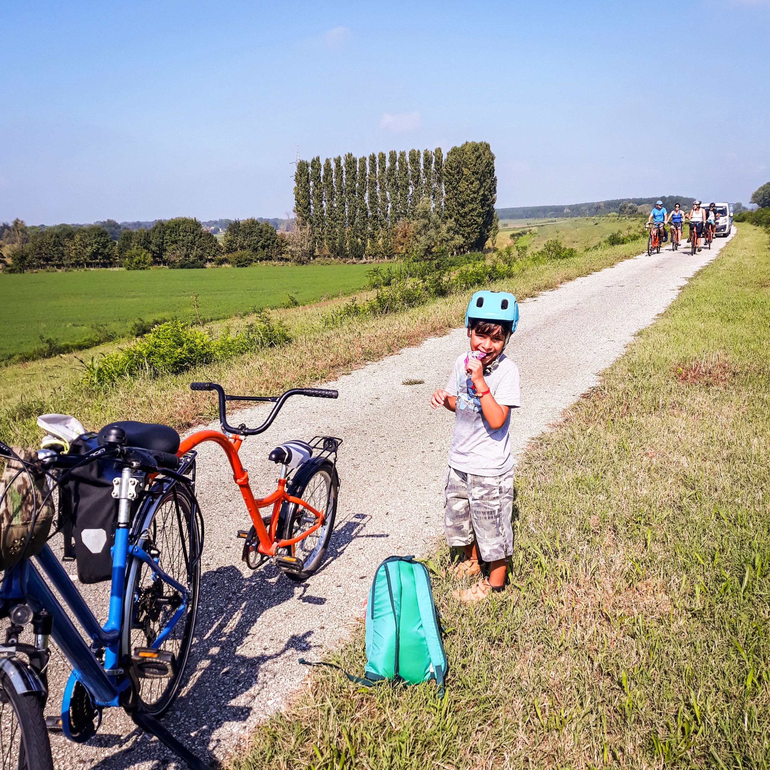 Bimbo vicino a bici "Girolibero" parcheggiate lungo la ciclabile lungo il Delta del Po, viaggi in bicicletta in famiglia