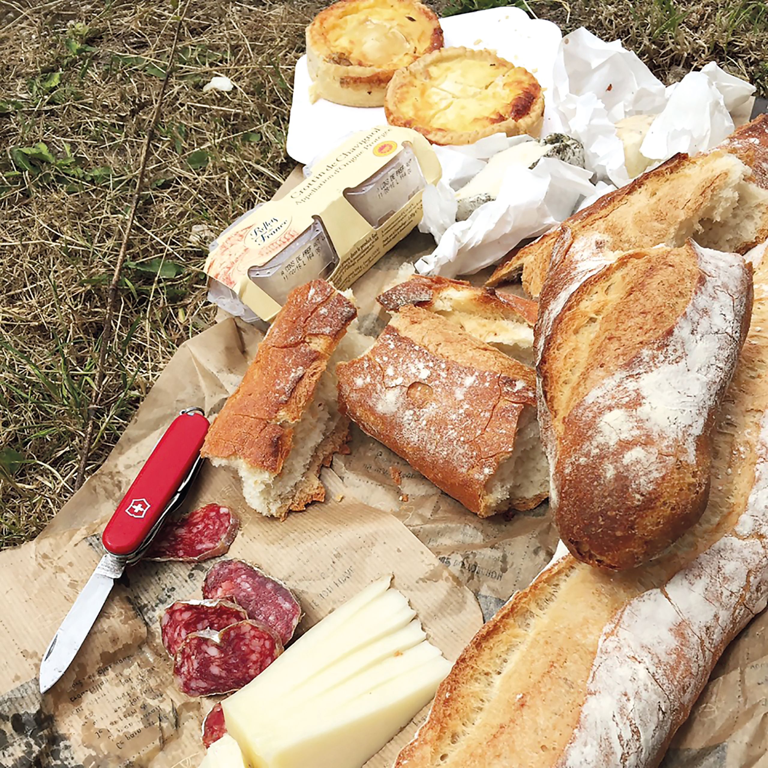 Cutting board with bread, cured meats and cheeses