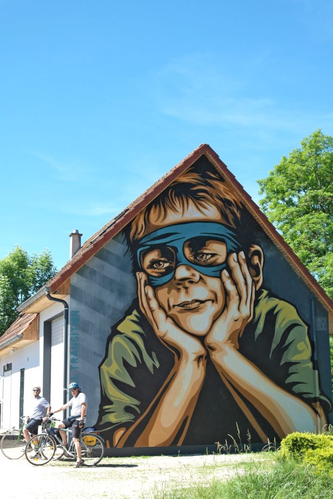 Murale colorato su un edificio raffigurante un volto mascherato, Borgogna, Francia
