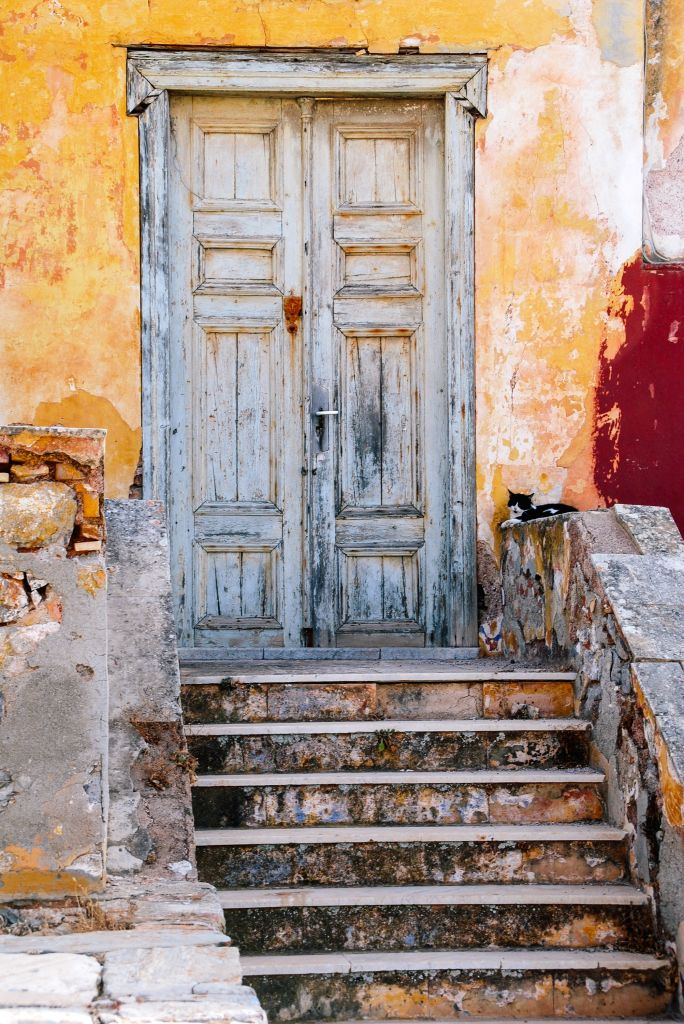 Blue door and stone staircase in a traditional Greek village.