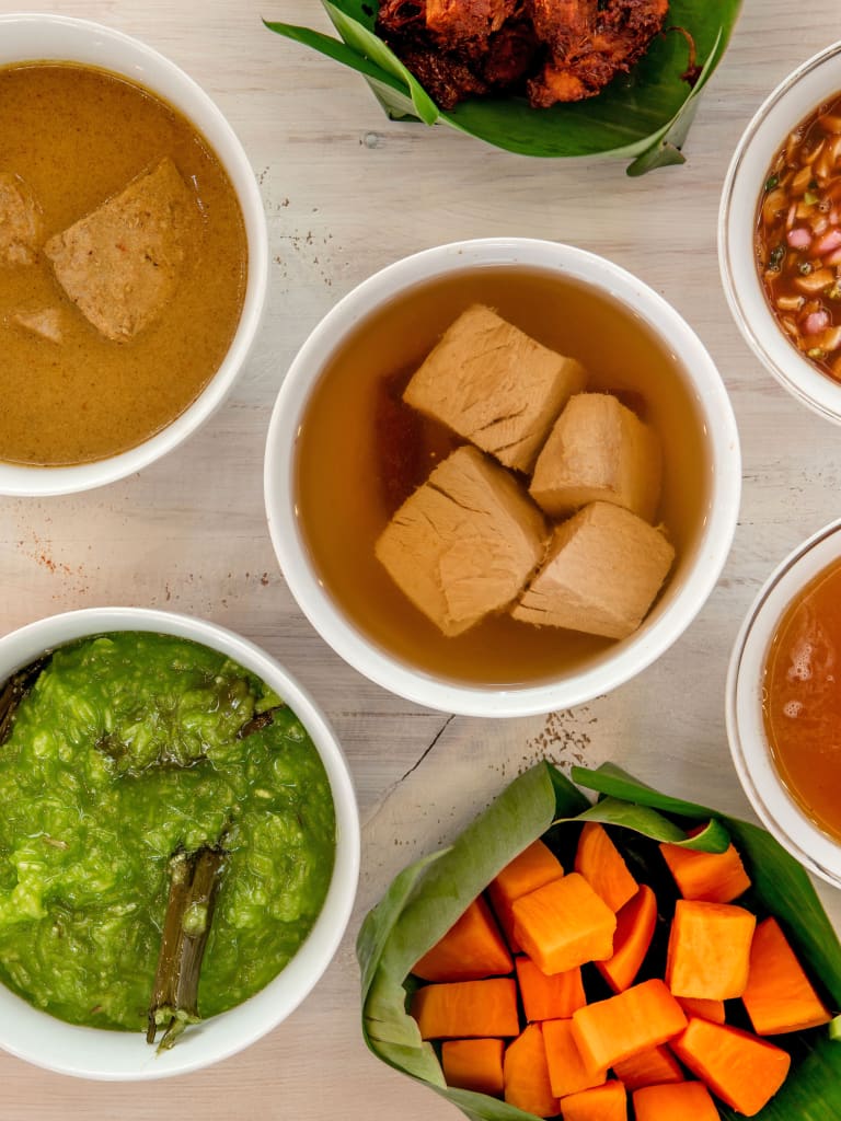 Ciotole con curry vegetale, chutney e frutta fresca tipici della cucina maldiviana