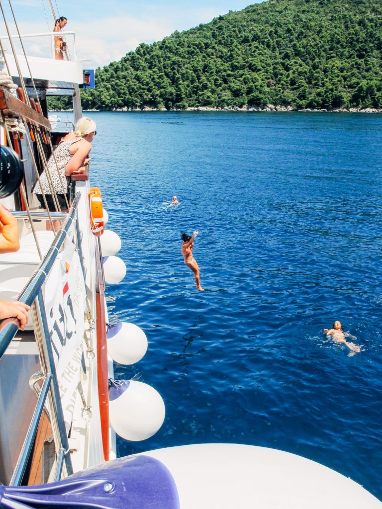 People jumping into the sea from a boat, boat trips in Croatia