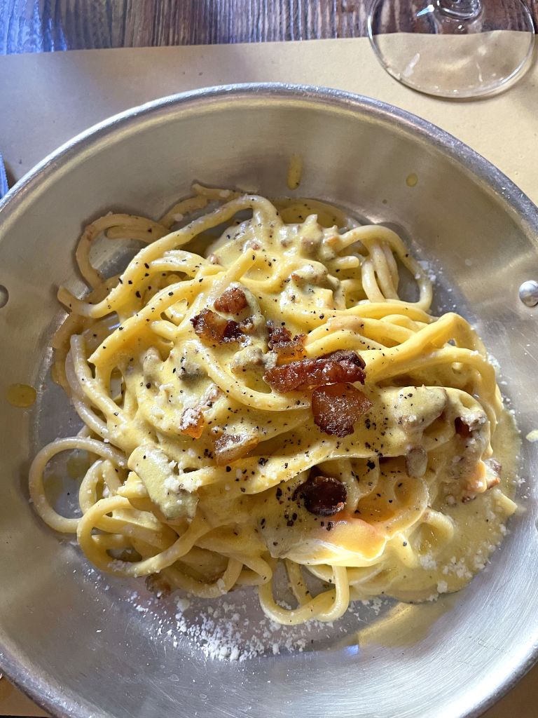 Plate of tonnarelli carbonara, a traditional Roman pasta dish.