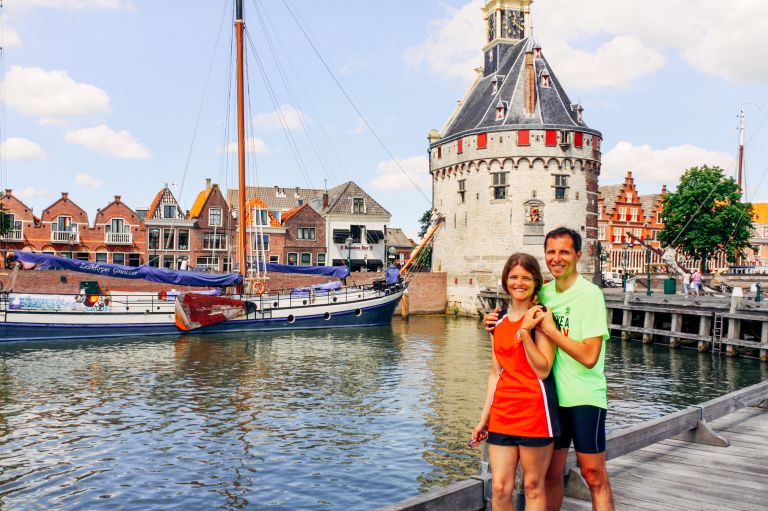Couple of tourists admiring the canals and traditional houses in Volendam, Netherlands