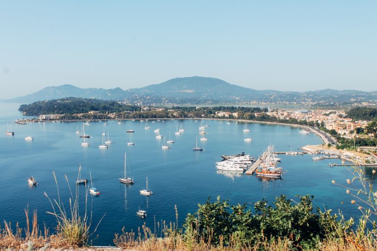 Top view of a port with boats and deep blue sea, Corfu