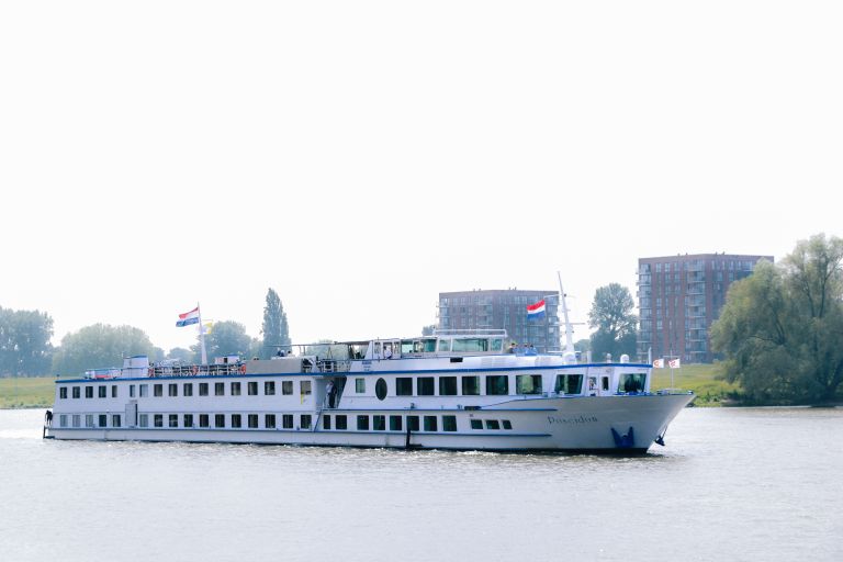River cruise ship sailing on a Dutch river.