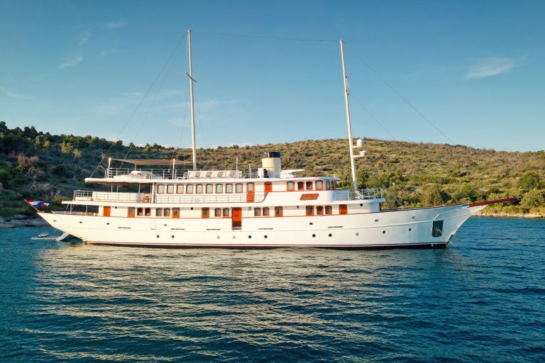 Cruise ship Bellezza anchored in the turquoise waters of the Croatian coast, Dalmatian Islands.