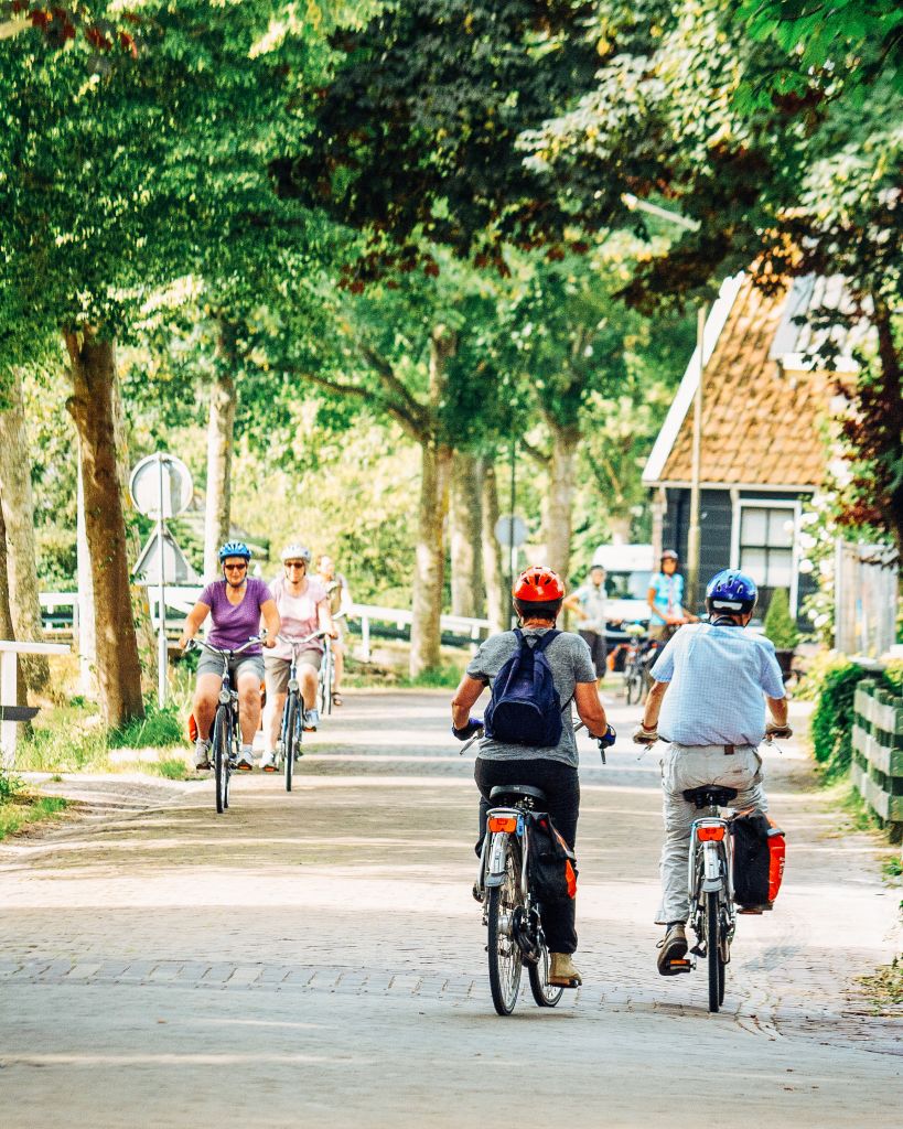 Family cycling on a bike path surrounded by Dutch nature