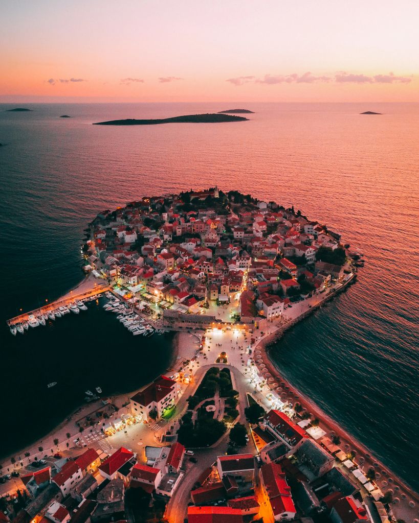 Aerial view of the island town of Primošten at sunset, Croatia.