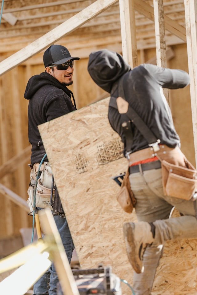 men holding plywood