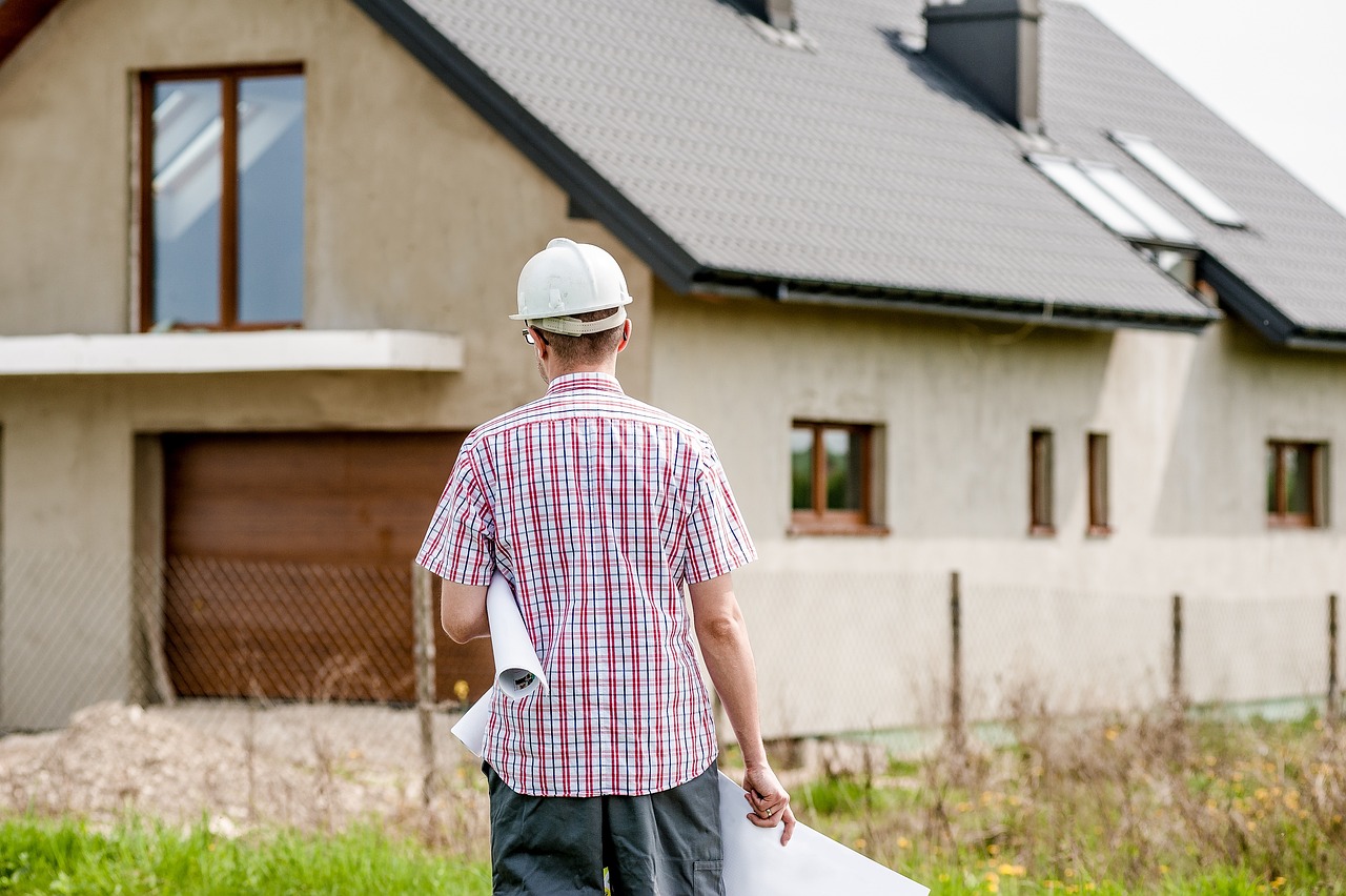 Man walking towards house with tools in hand