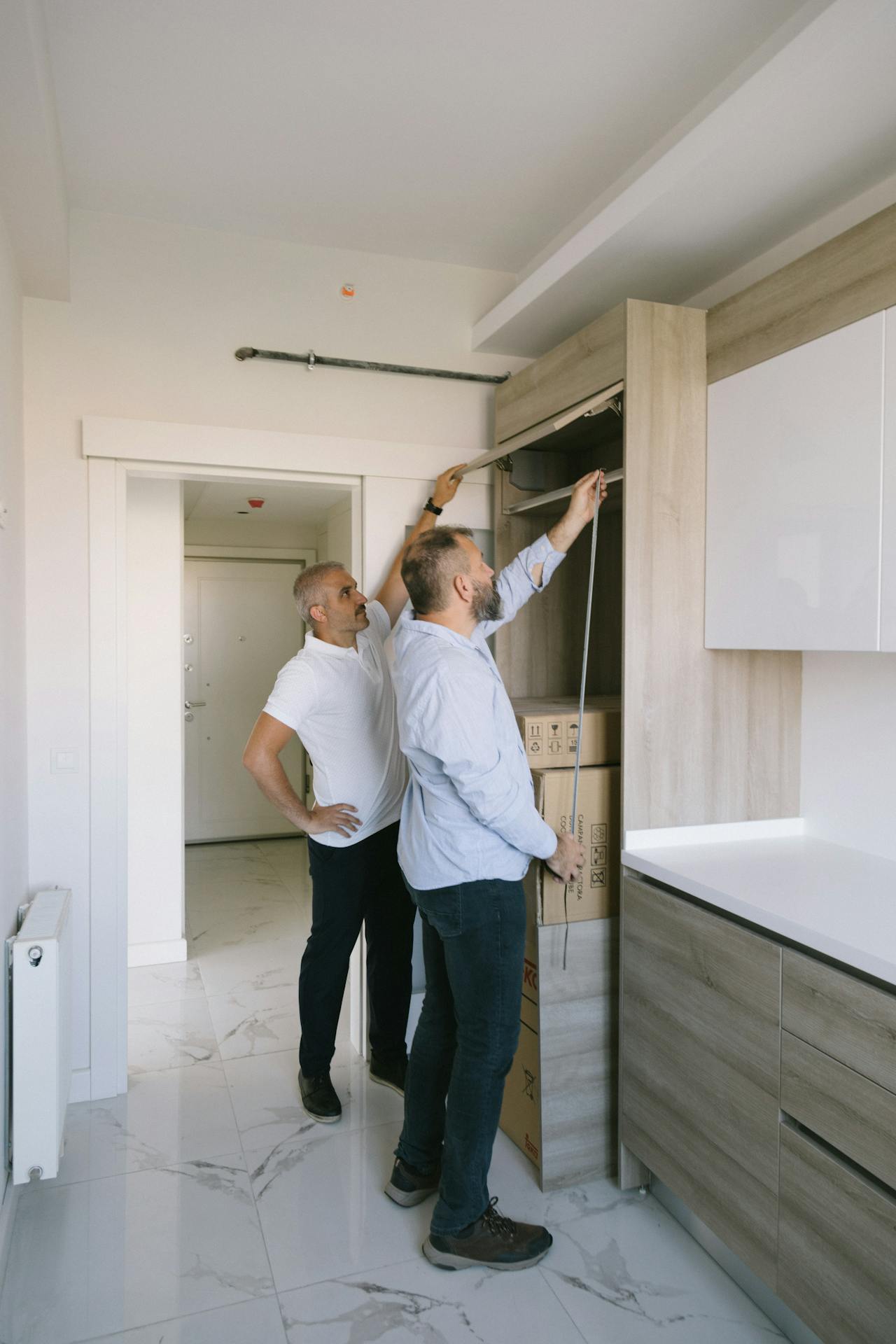 people inspecting a cabinet