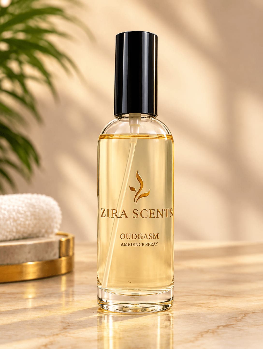 Zira Scents Oudgasm ambience spray in a clear glass bottle on marble