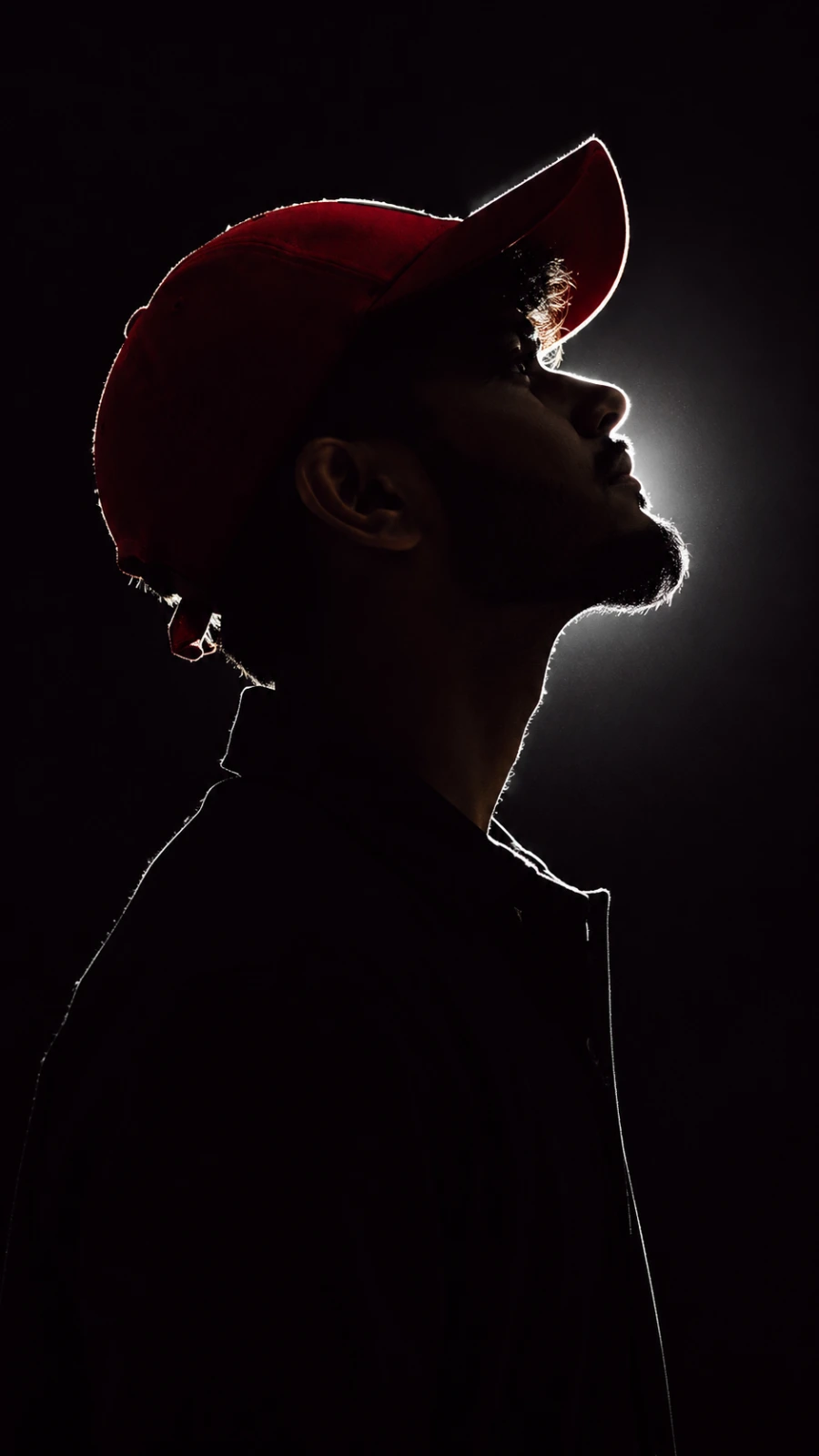 Skyward Silhouette in a Red Cap