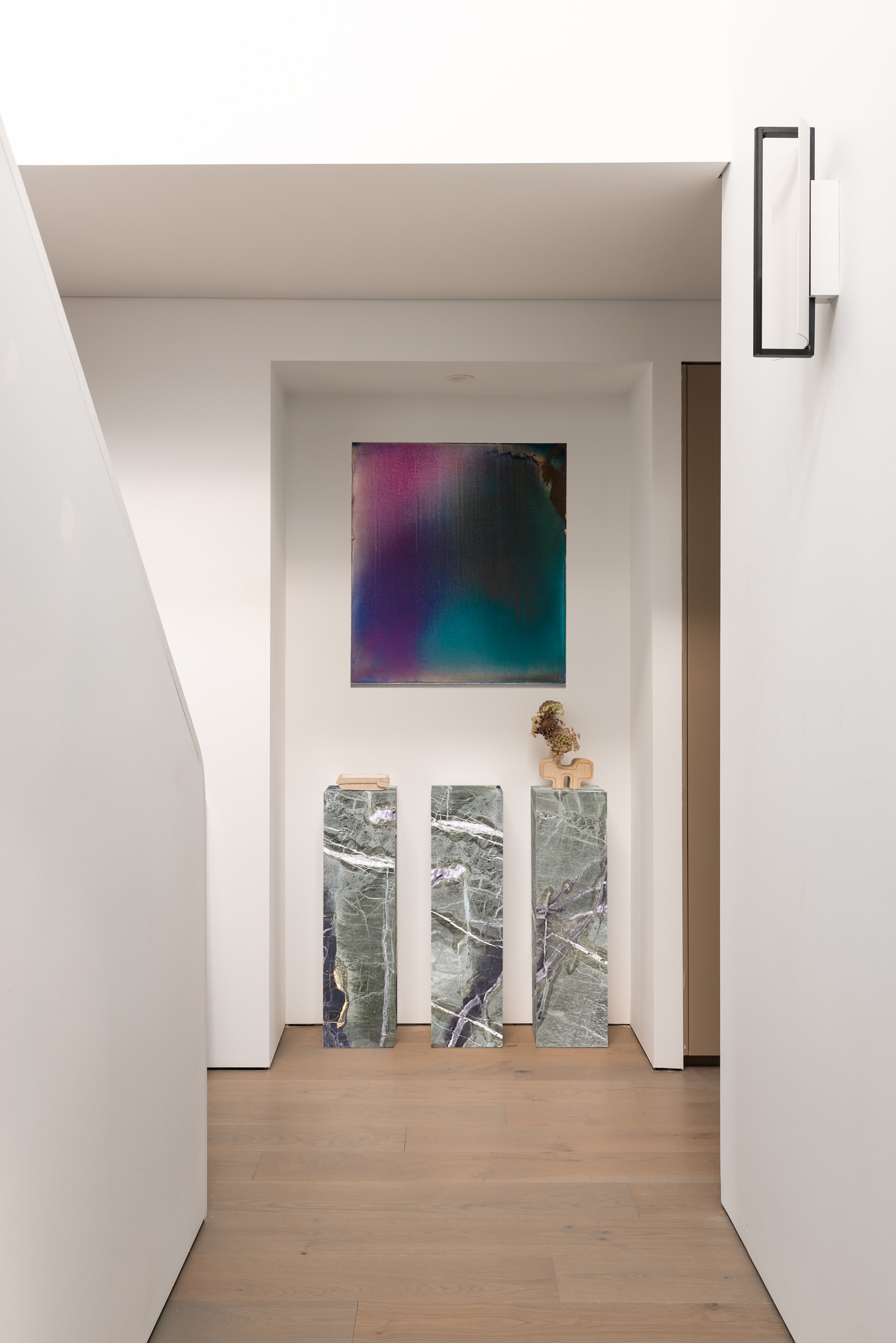 A residential entry with concealed storage and soft lighting