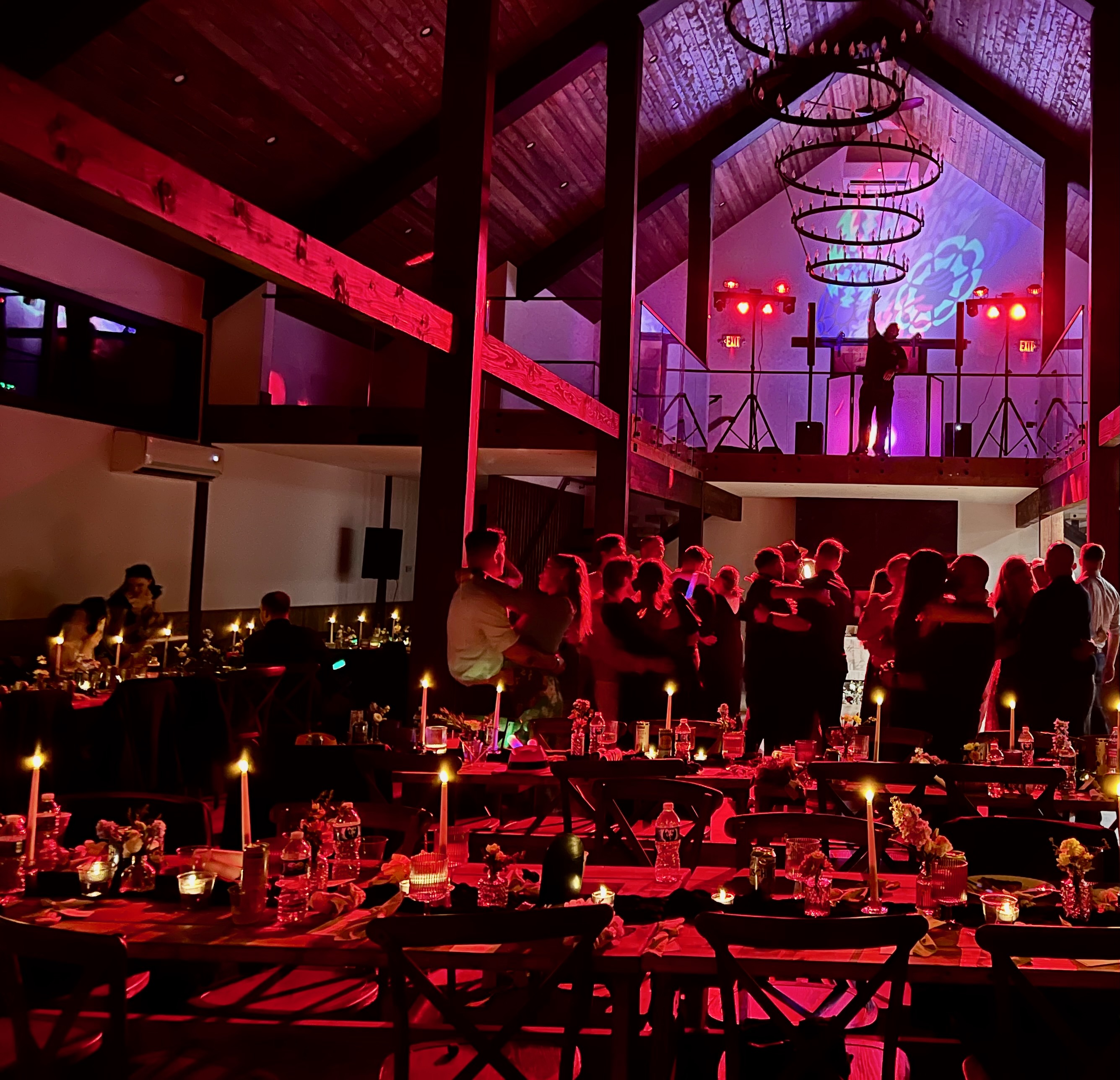 Wedding reception dance floor with red lights and DJ at Mountain Meadows barn Catskills venue