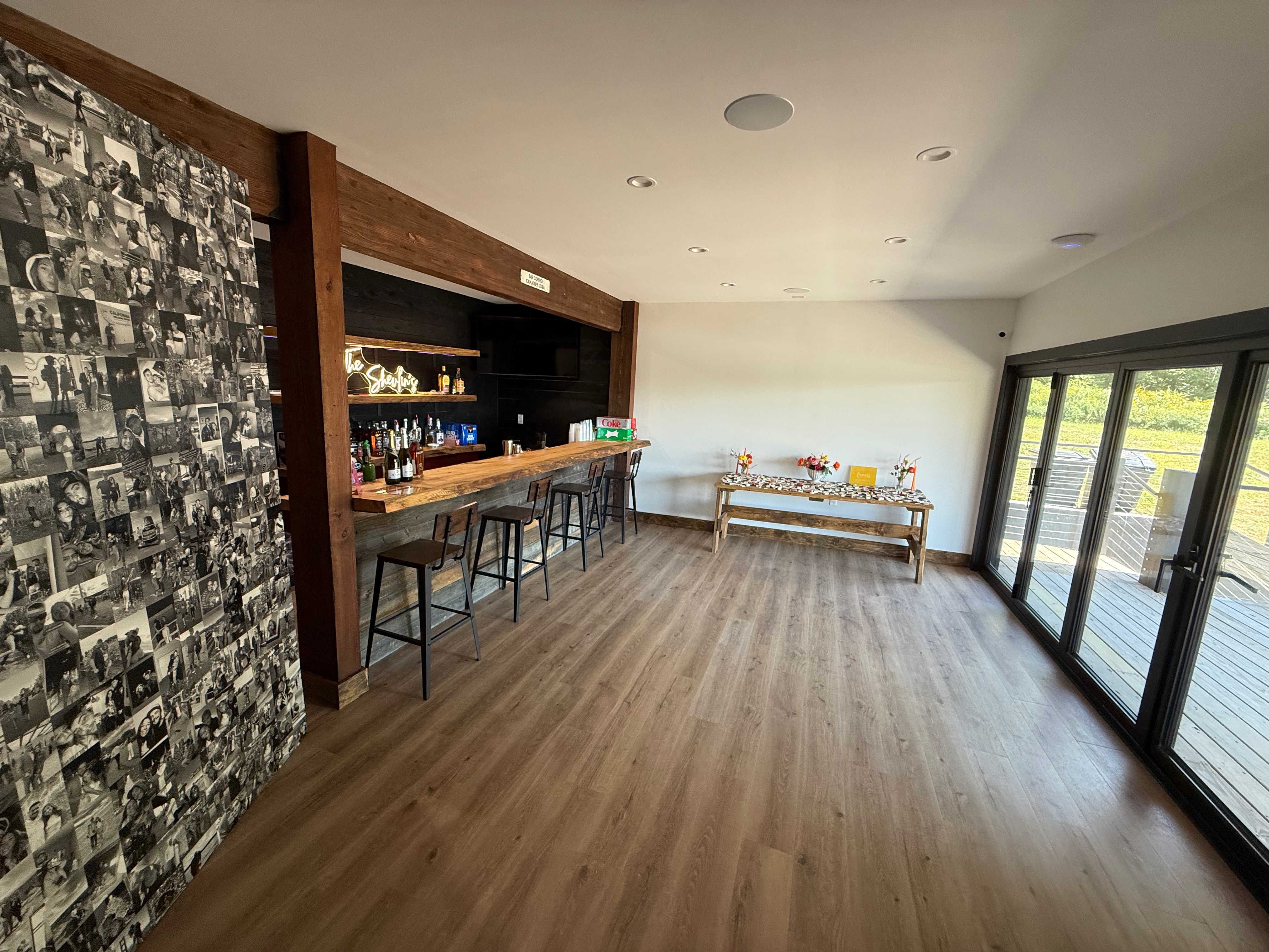 Cocktail hour bar area with photo wall at Mountain Meadows Catskills wedding venue