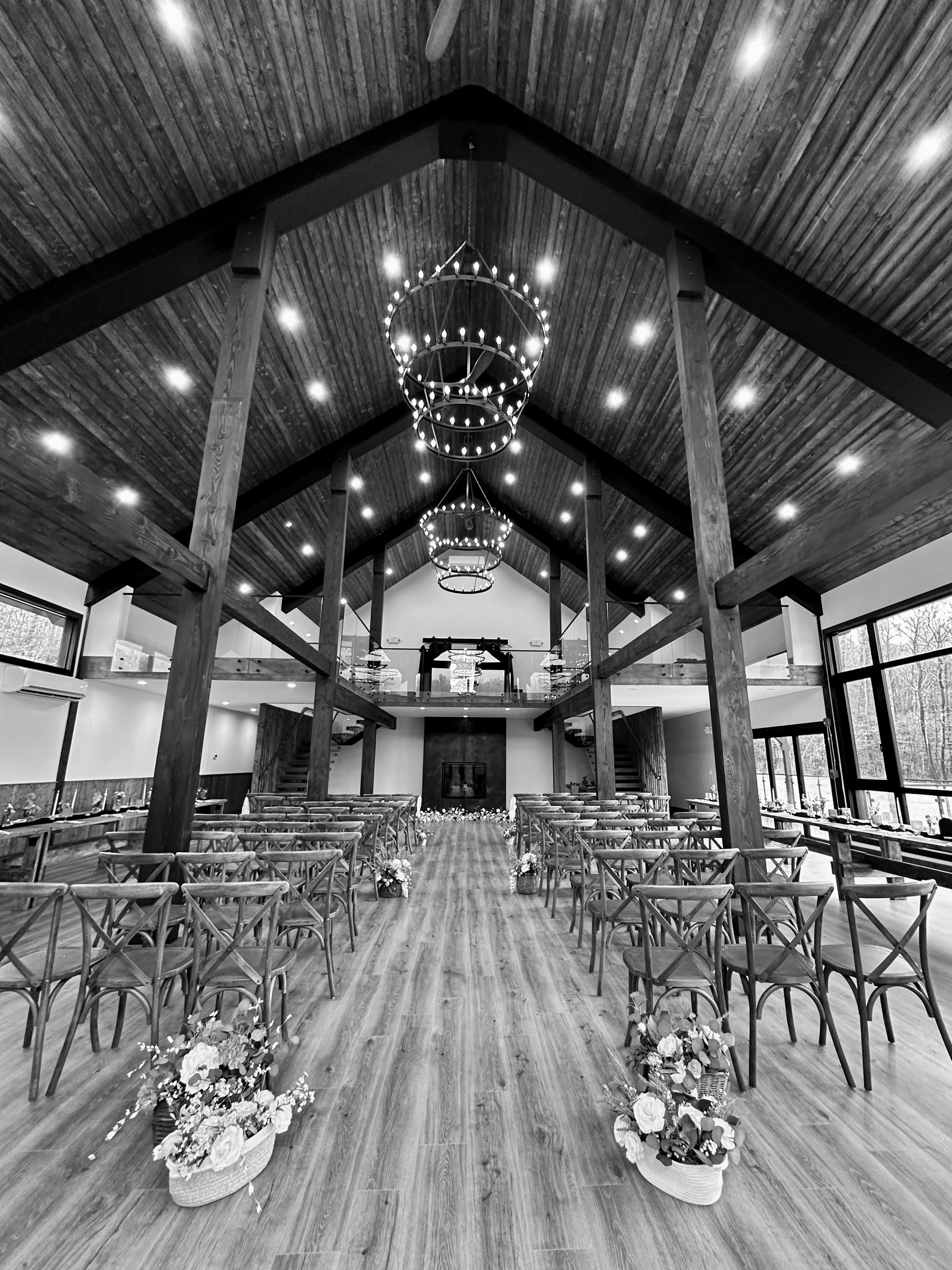 Barn interior set for wedding ceremony with aisle and chandeliers at Mountain Meadows Catskills venue