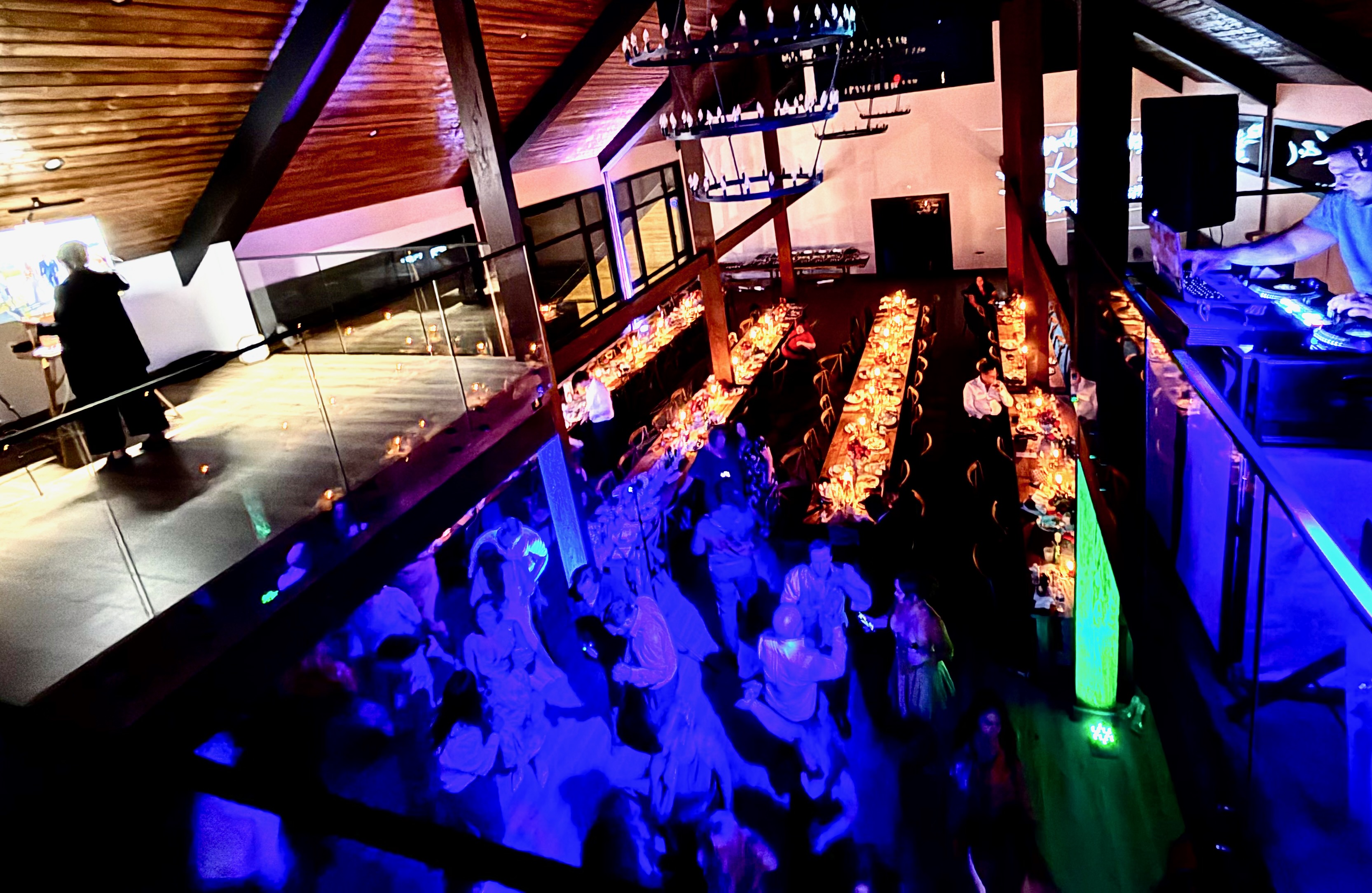 View from mezzanine overlooking barn wedding reception setup at Mountain Meadows Catskills venue