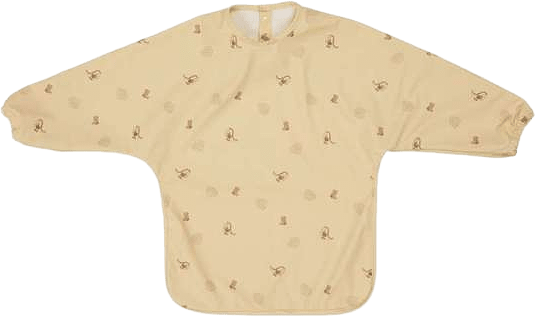 Dino Cape Bib, från OYOY Mini, i färgen butter.